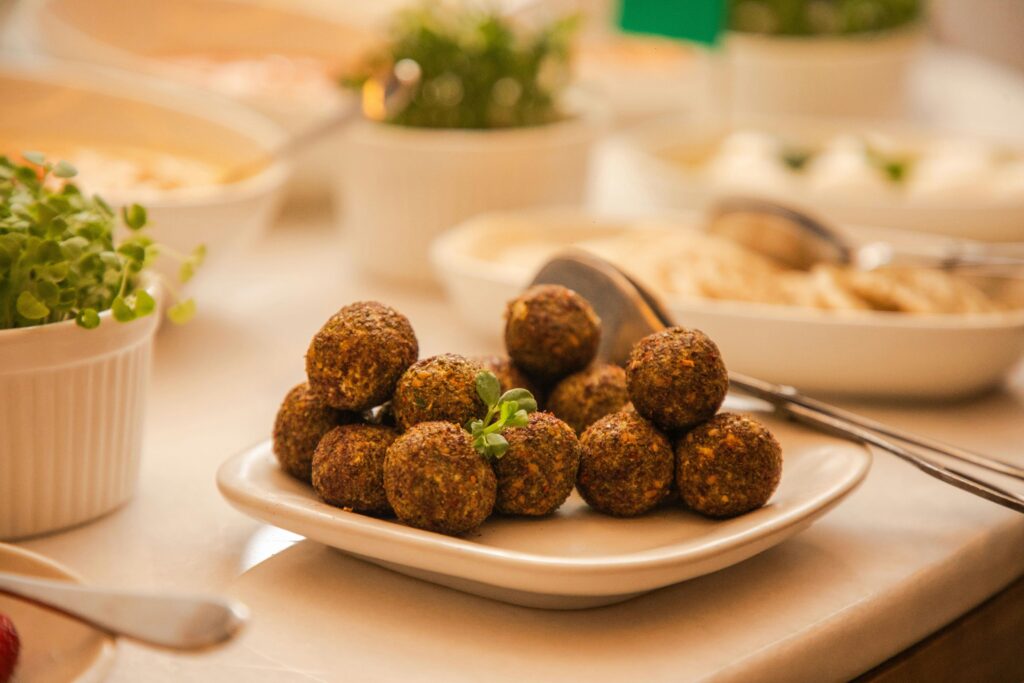 Tasty falafel balls served on a plate with fresh greens, ideal for dining and food enthusiasts.